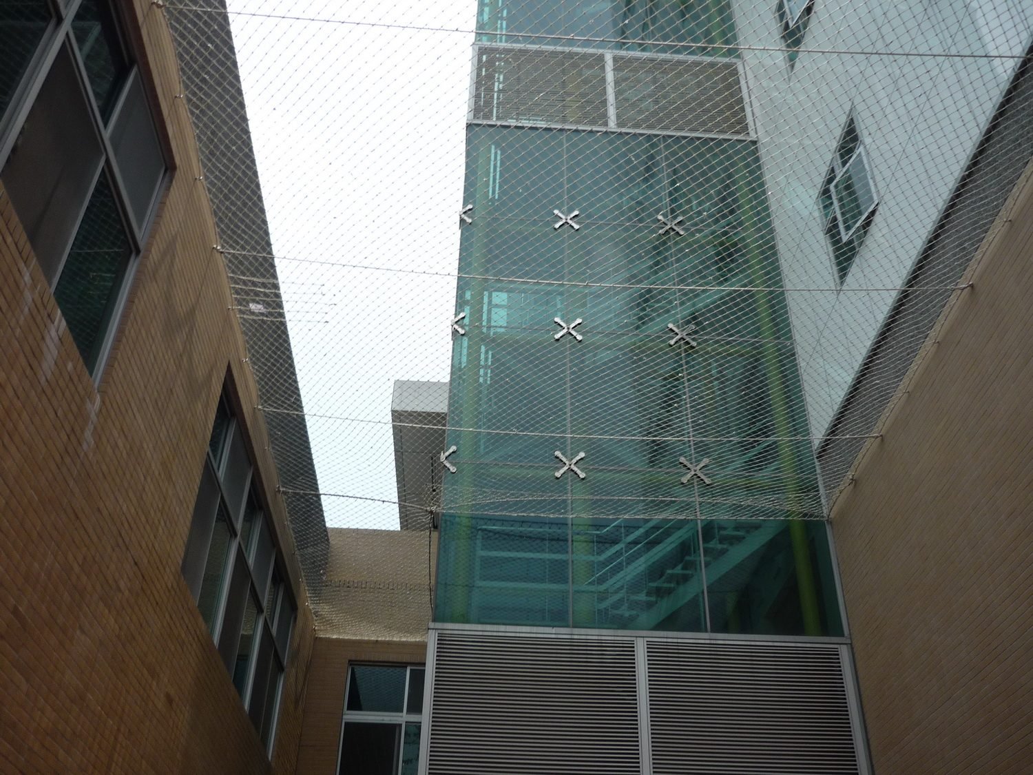 Protective netting outside a glazed lift shaft