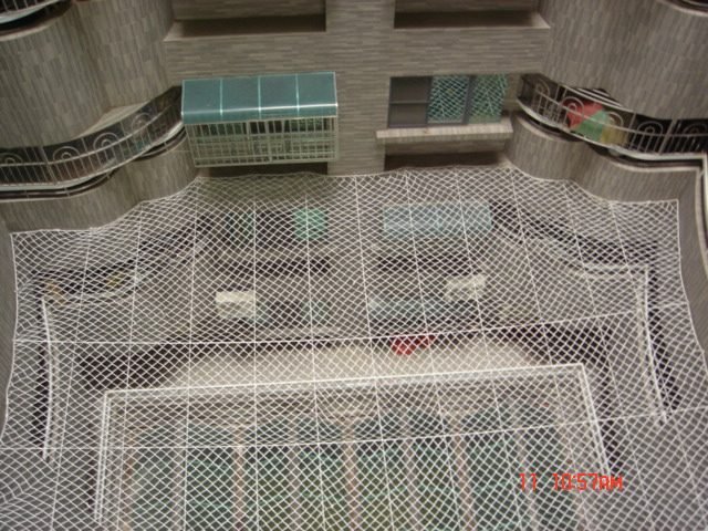 Horizontal fall-arrest netting in a light well
