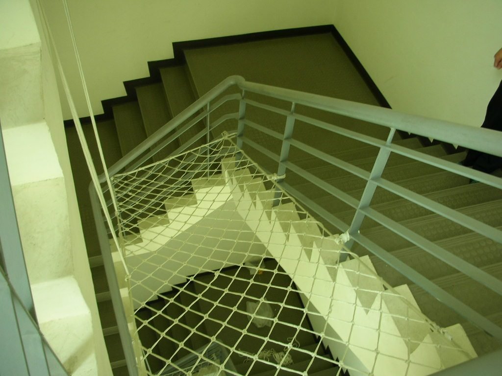 Protective netting at a stair landing