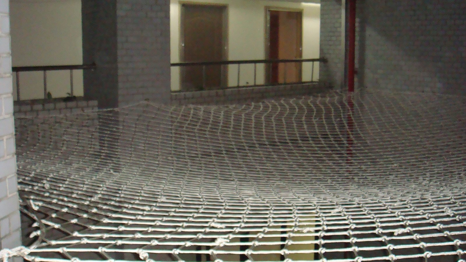 Large-span fall-arrest netting in a light well