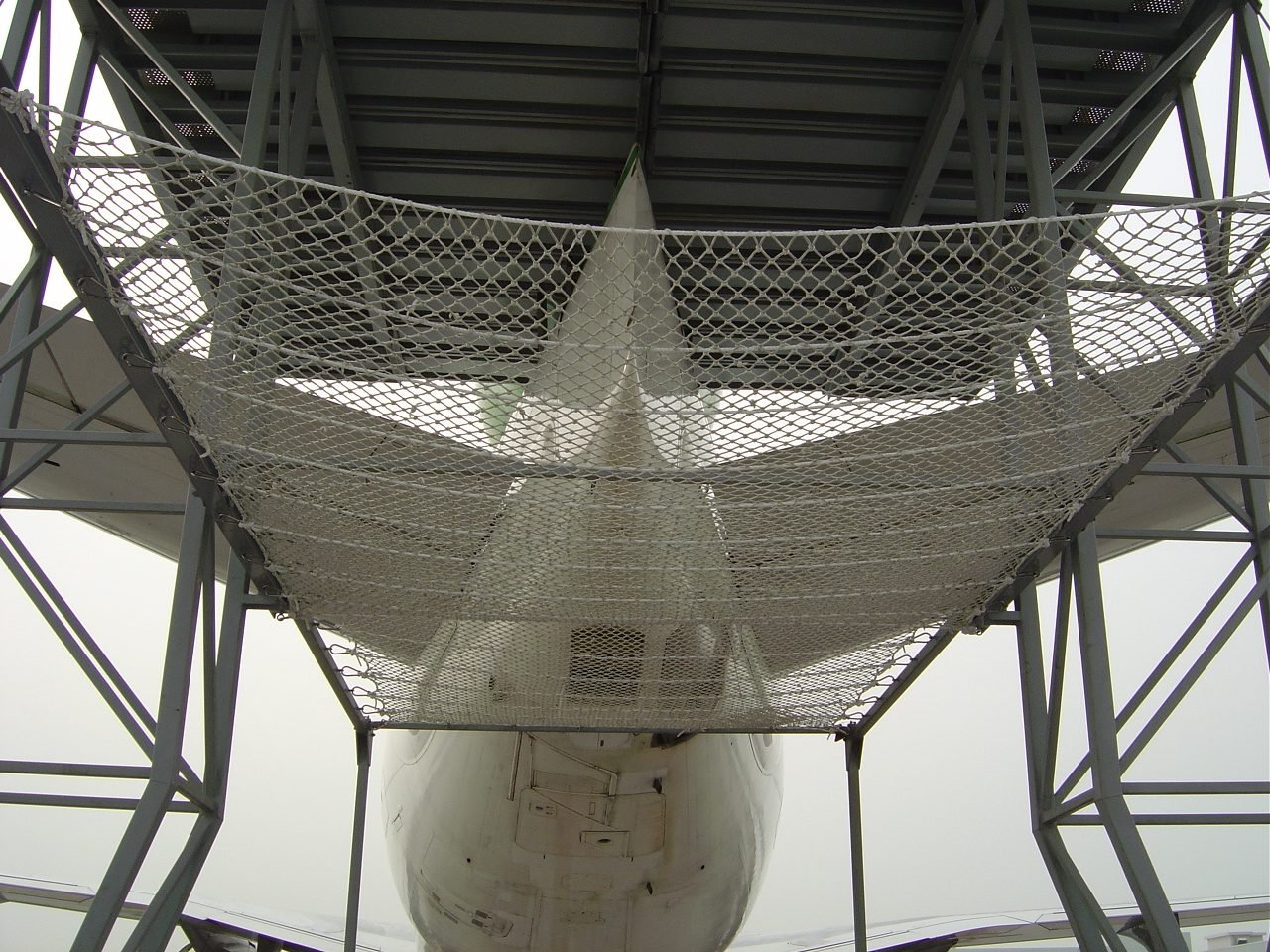 Protective netting beneath a tower structure