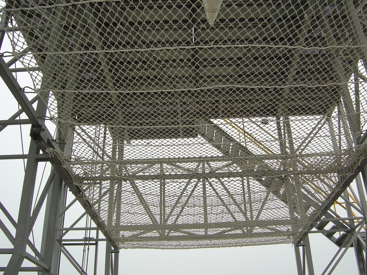 Protective netting under a steel tower