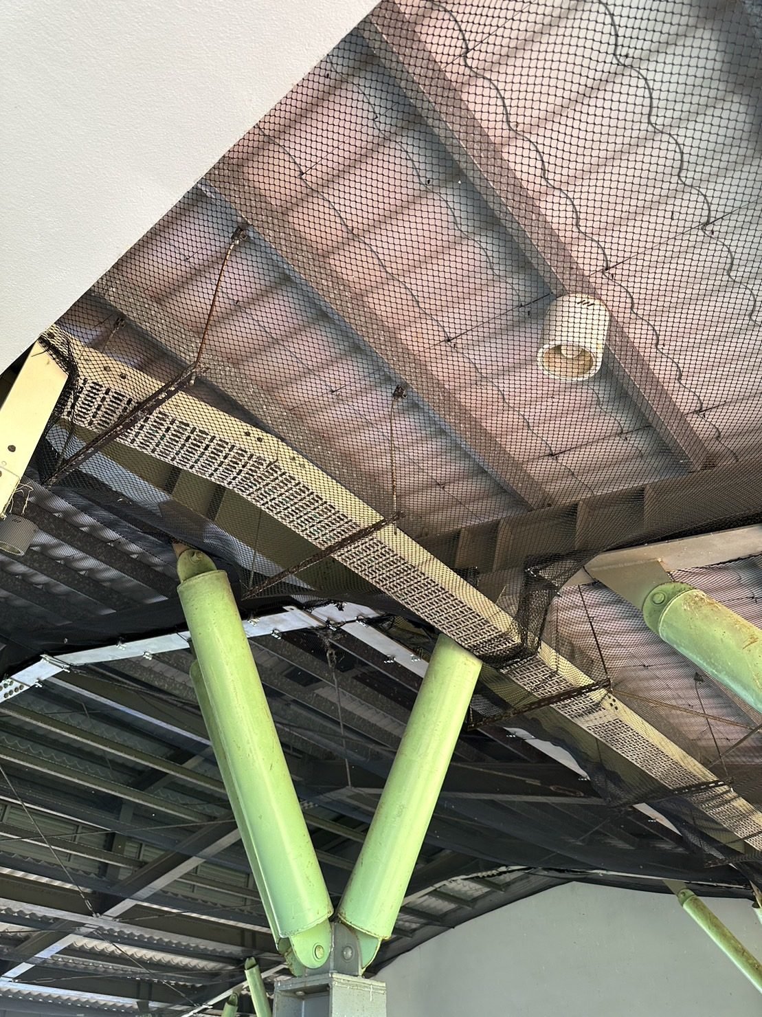 Netting under a school roof structure